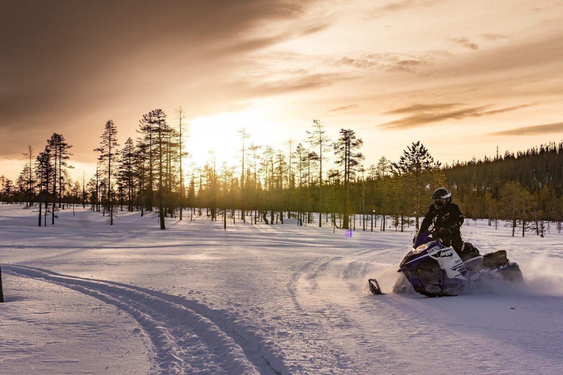 Snowmobiling during sunset