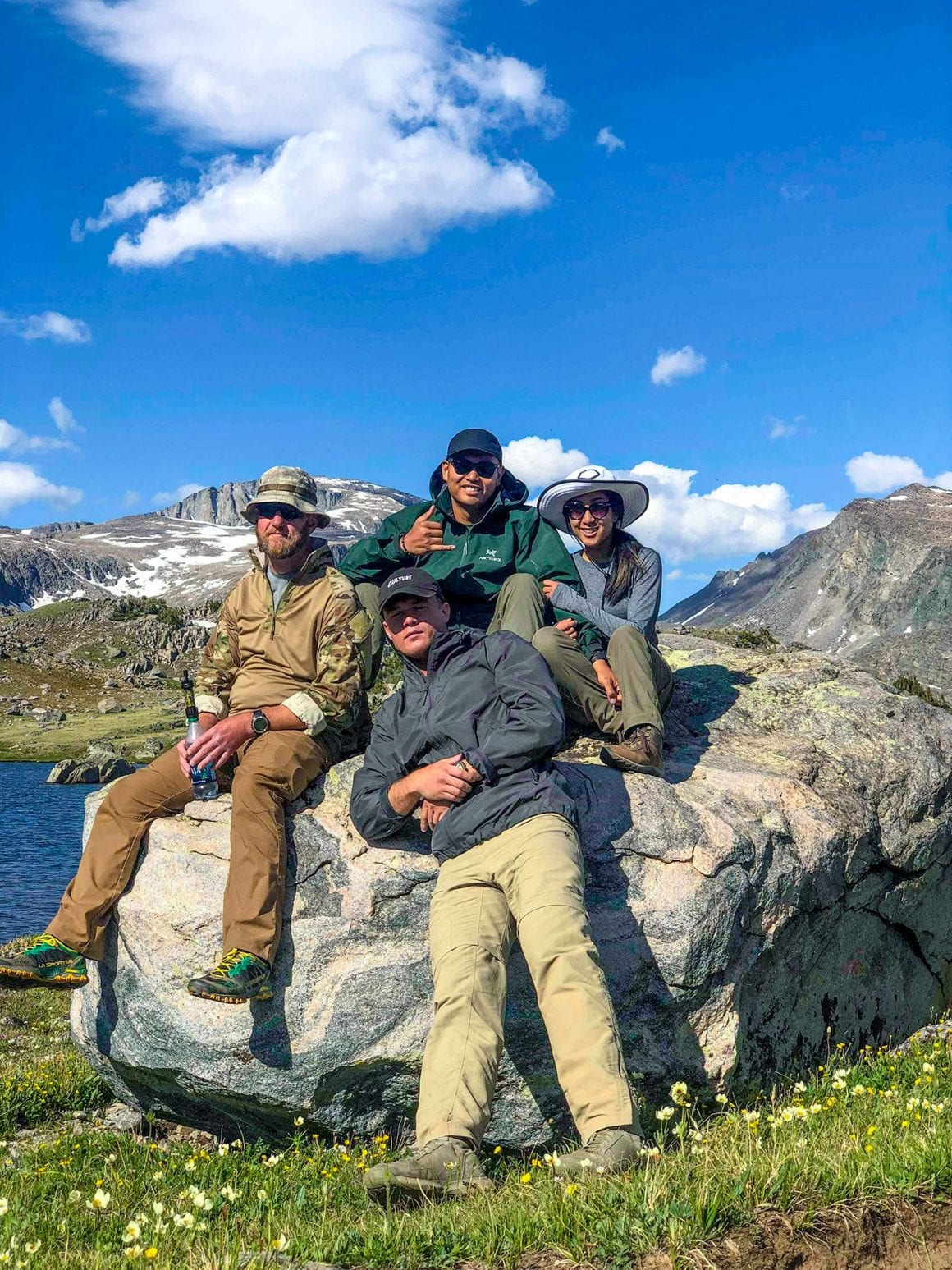 Christina and Emil hiking in mountains with friends.